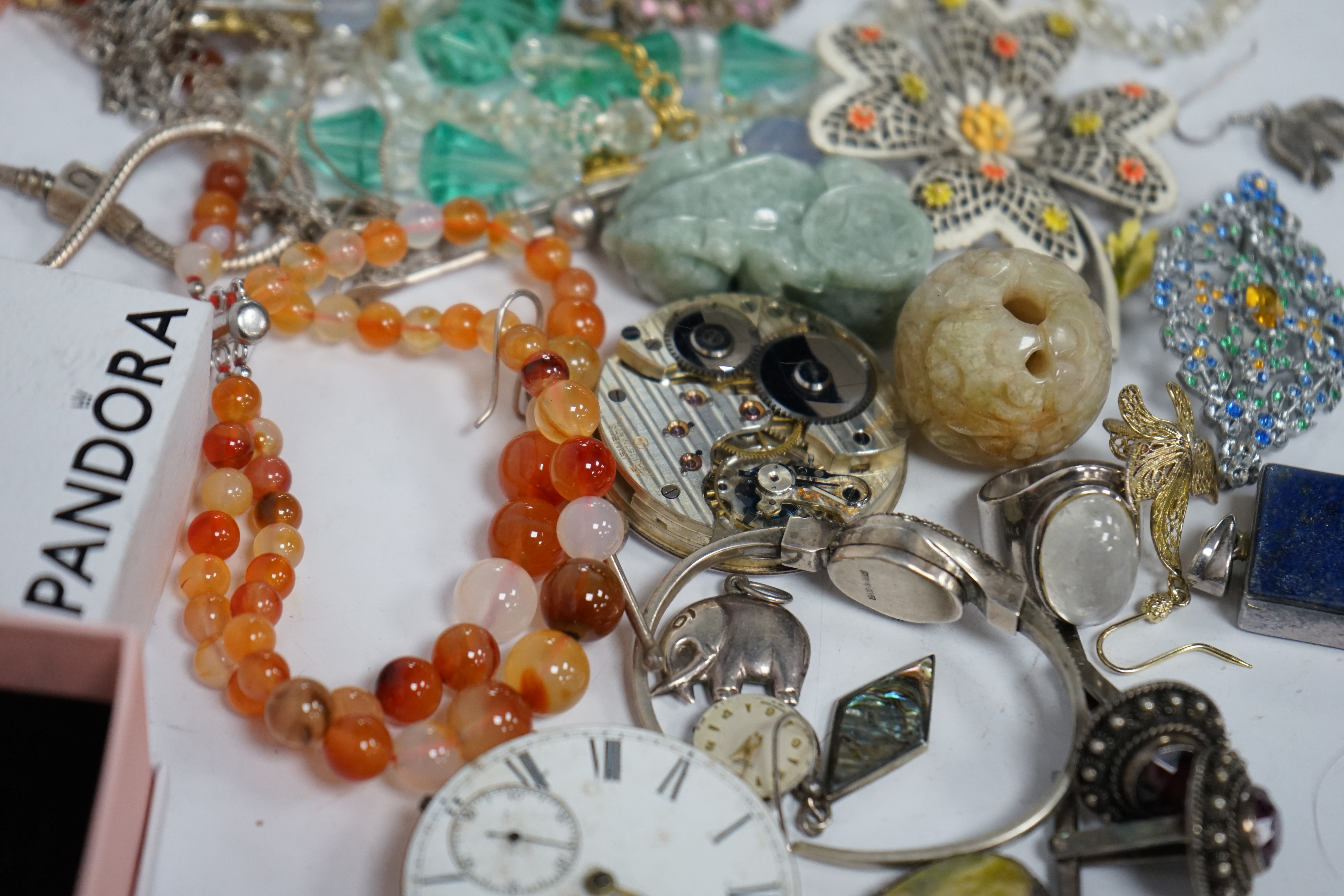 A small quantity of assorted jewellery and other items including a filigree butterfly brooch, a 925 and labradorite ring, an agate bead necklace, pocket watch movements, etc. Condition - poor to fair
